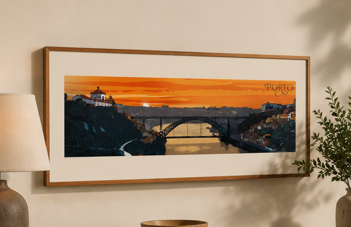A framed panoramic art print of Porto, Portugal, featuring a vibrant orange sunset over the Douro River and historic cityscape, styled on a beige wall with a lamp and plant nearby.