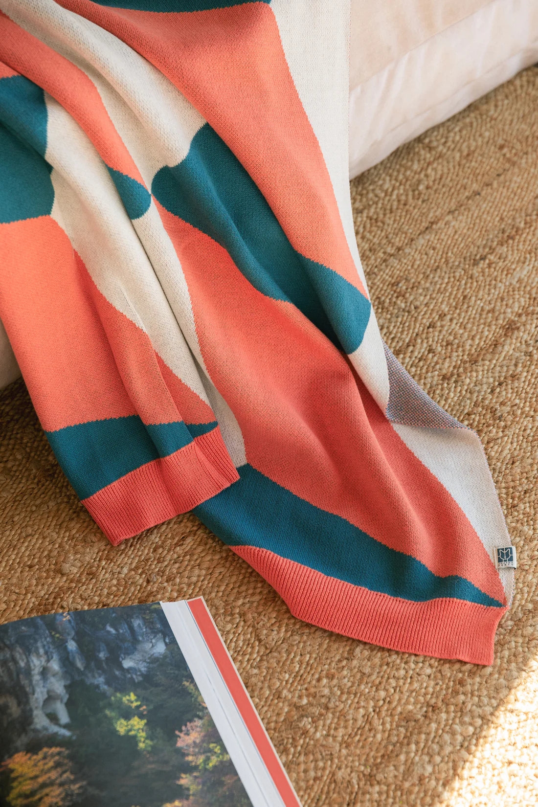 Striped fabric with orange, blue, and beige colors on a textured surface