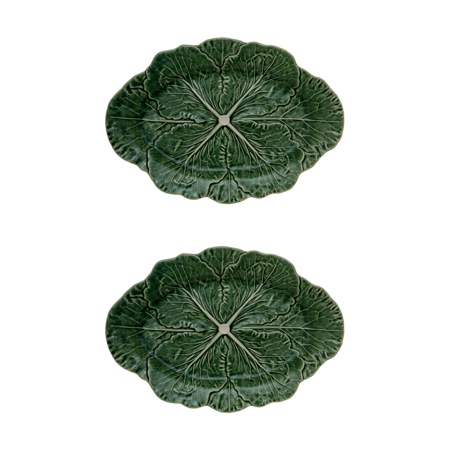 Two green ceramic leaf-shaped plates on a white background
