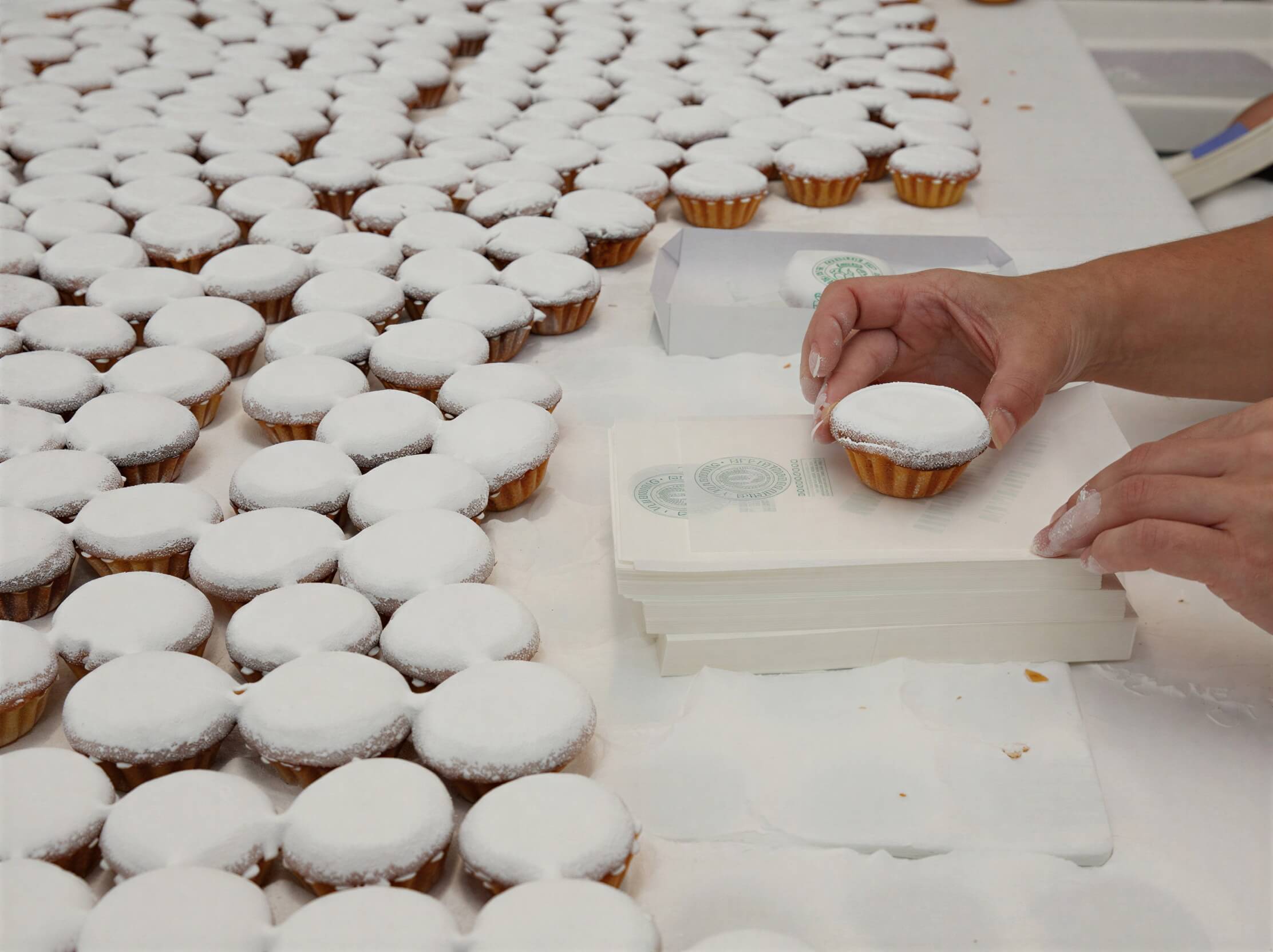 Worker making Queijadas De Vila Franca Do Campo Do Morgado Portuguese Custard Cakes