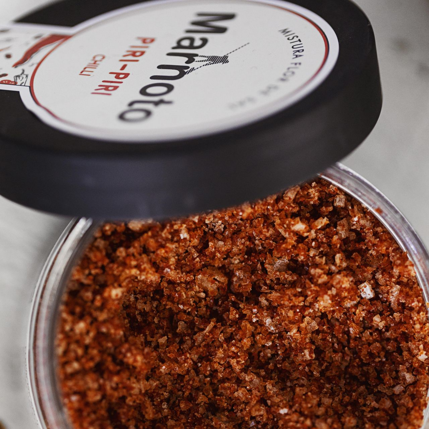 Container of marmato with a visible brand label on a neutral background