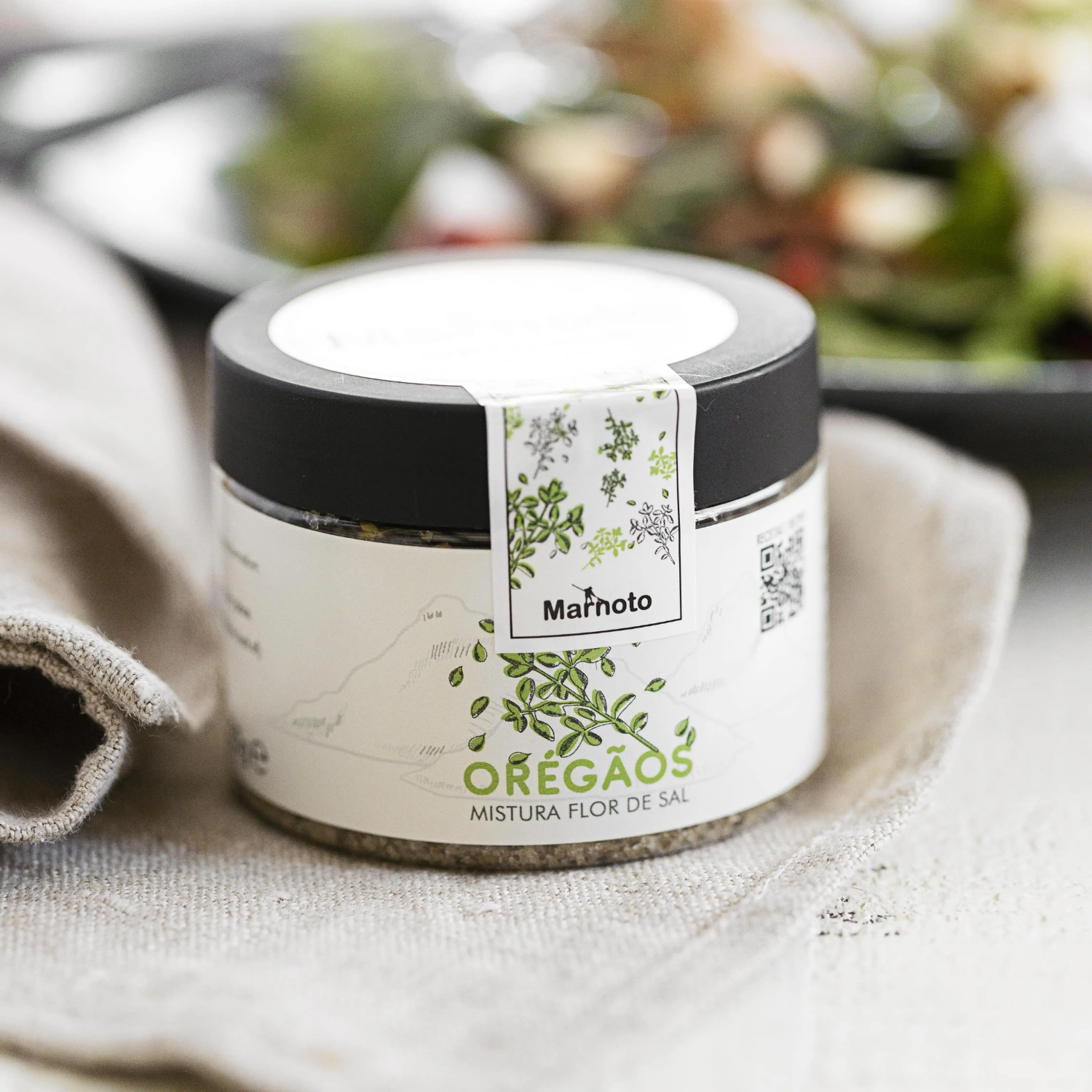 Jar of oregano with a visible brand label on a textured surface.