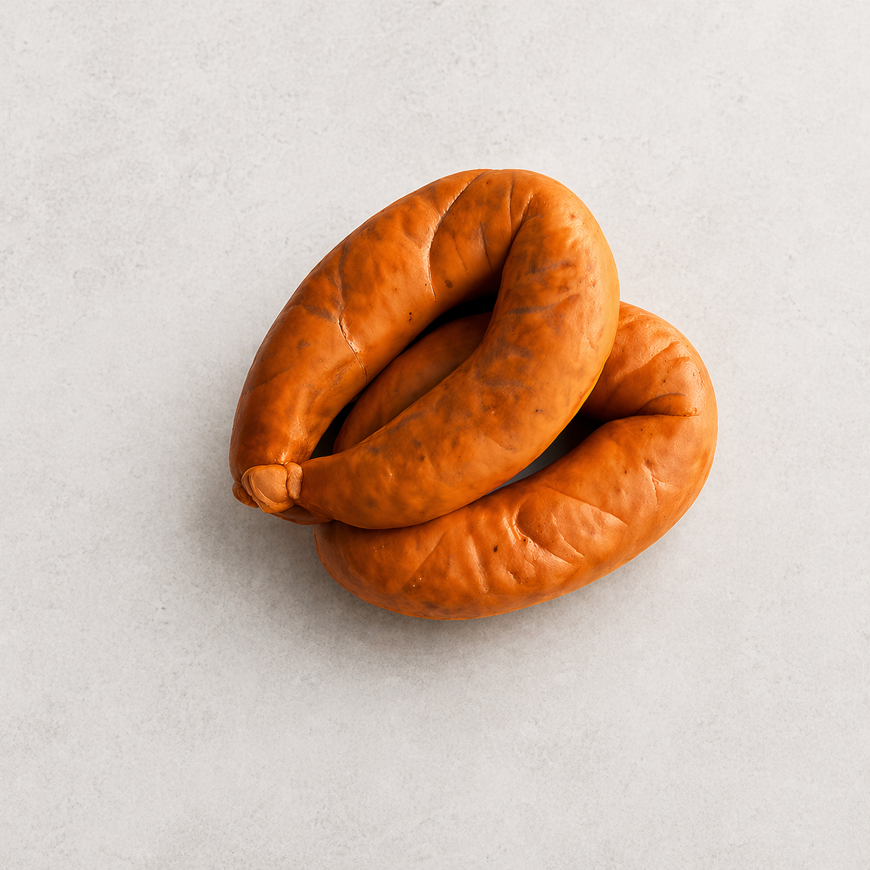 Alheira sausage in a twisted shape, featuring a rich orange-brown color on a light gray background.