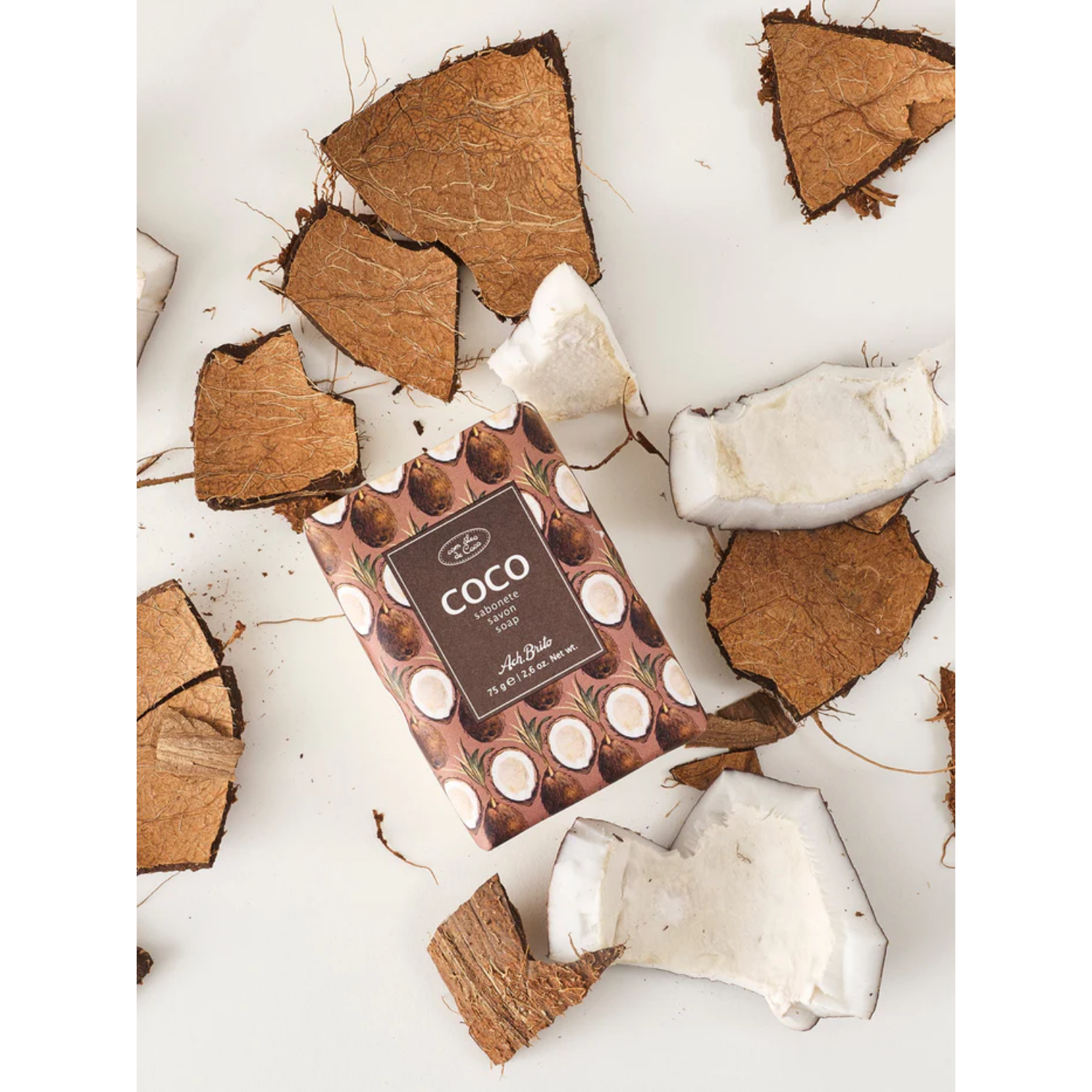 Coco soap bar with coconut pieces on a white background