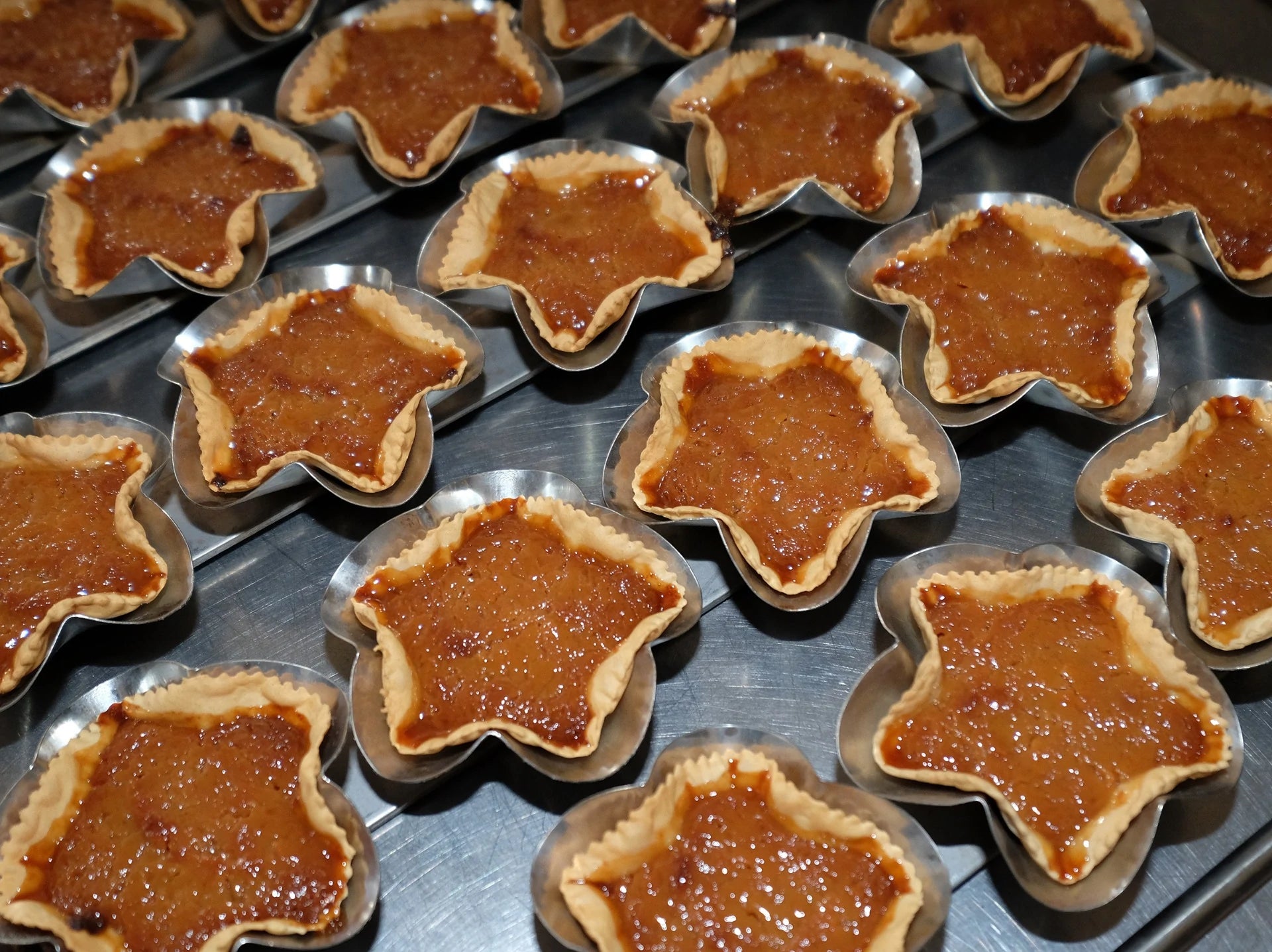 Queijadas da Graciosa in star-shaped pastry shells, filled with a golden-brown sweet filling.