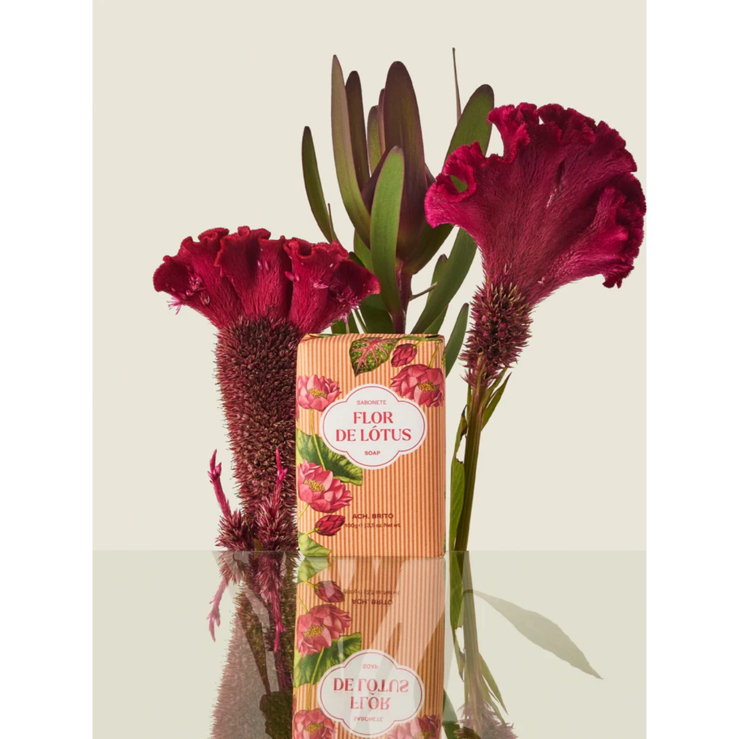 Flor de Lotus packaging with red flowers on a light background