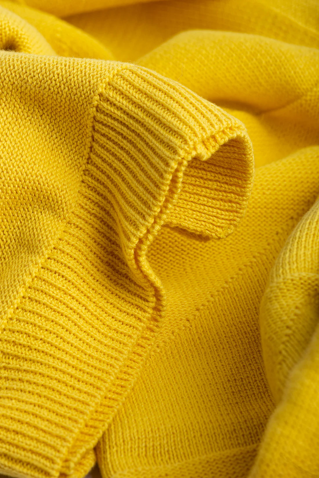Close-up of a yellow knitted fabric texture