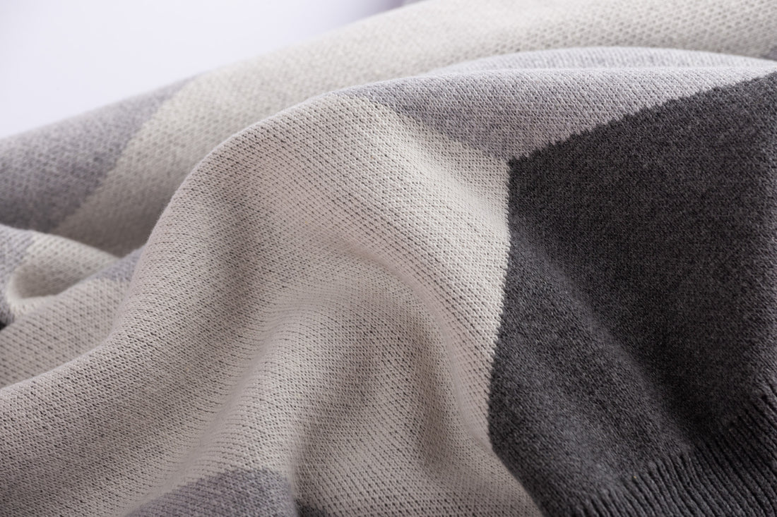 Close-up of a textured fabric with gray and beige colors.