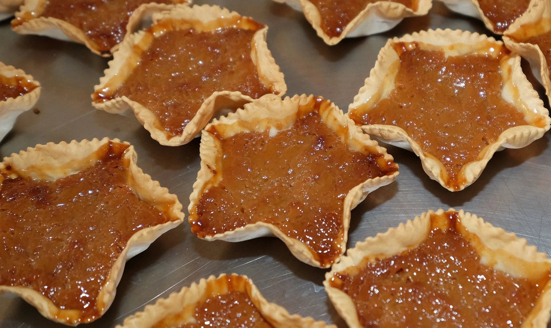 Queijadas da Graciosa, star-shaped pastries with a golden brown filling.