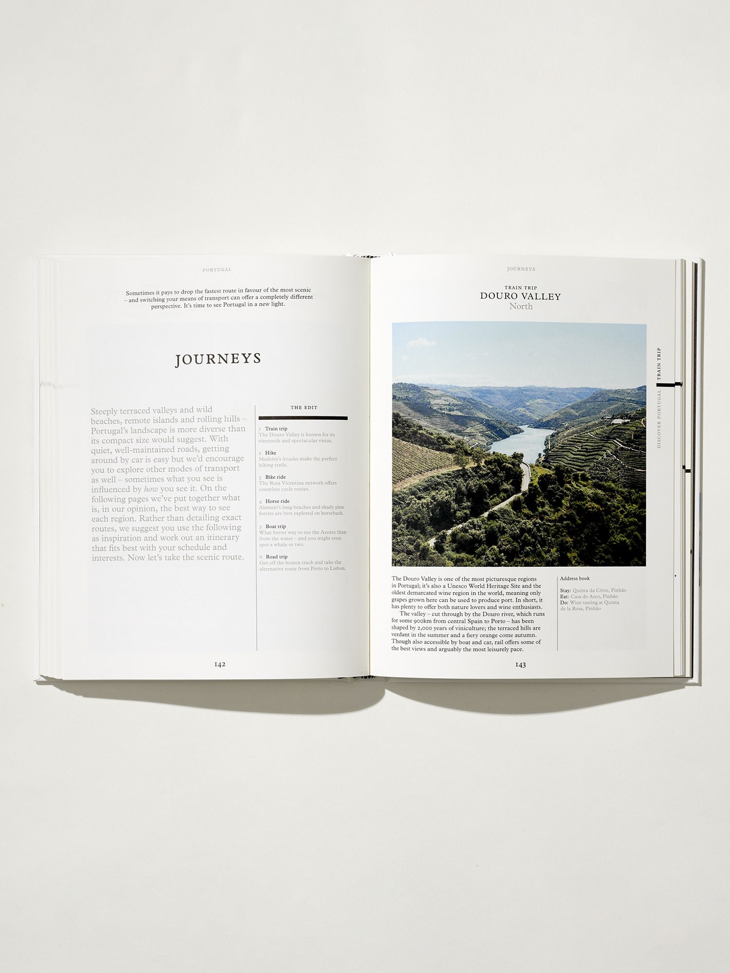 Open book with a scenic photograph and text on a white background