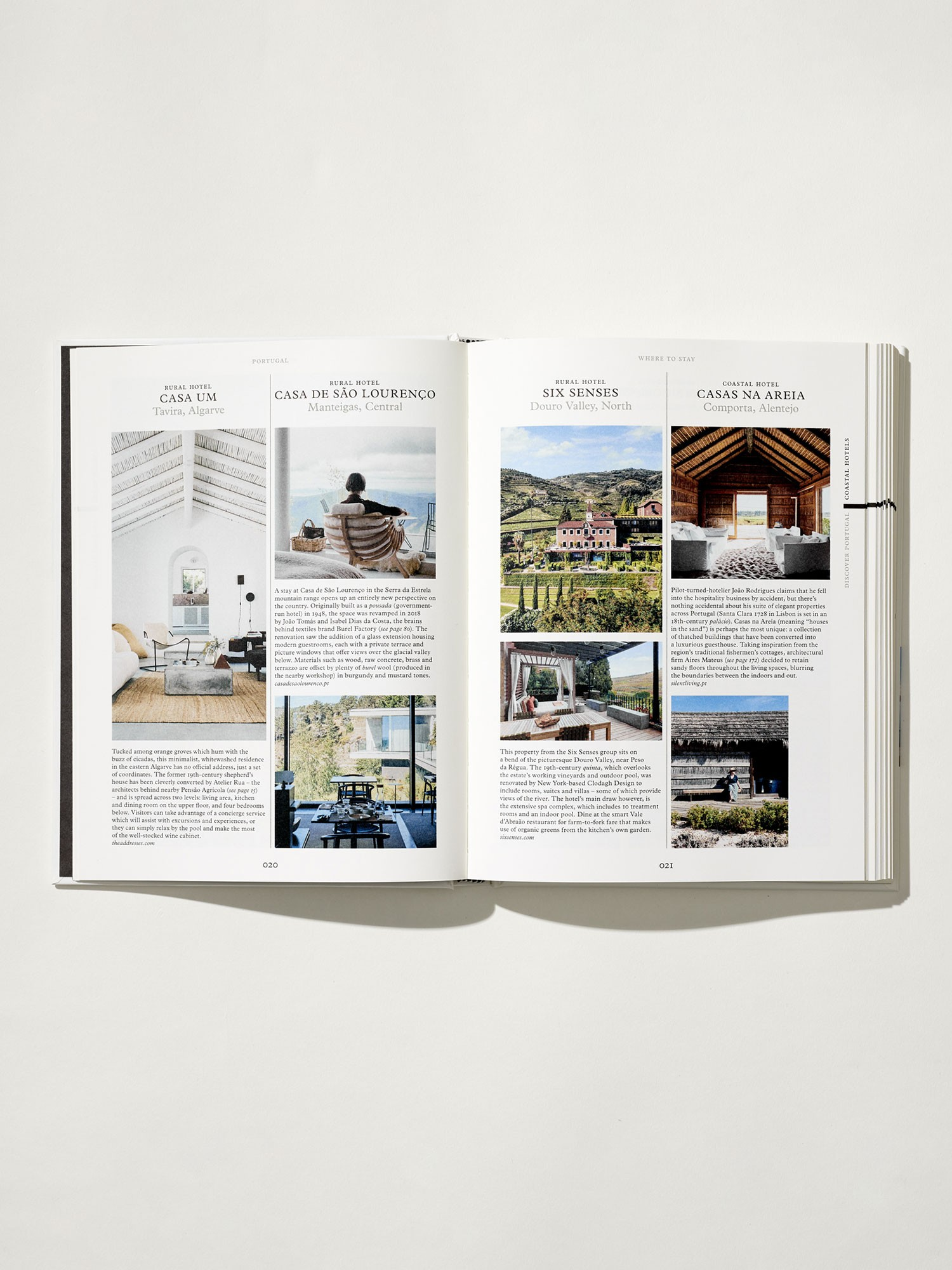 Open book showing interior design images and text on a white background